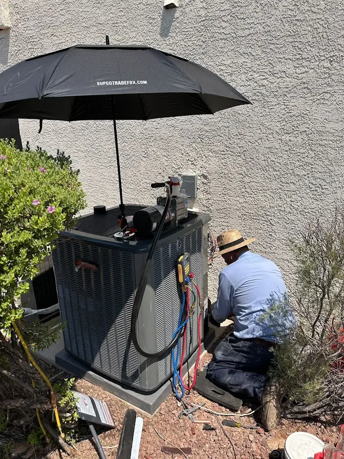 HVAC technician performing outdoor AC maintenance in Laplace