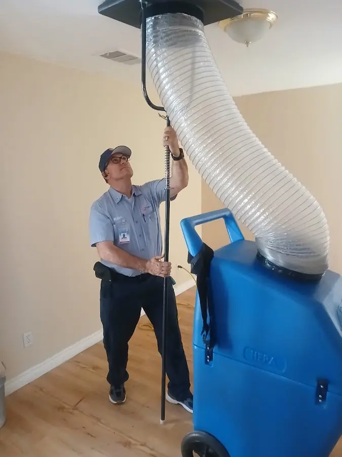 Furnace Tune-Up technician using HEPA equipment in Laplace